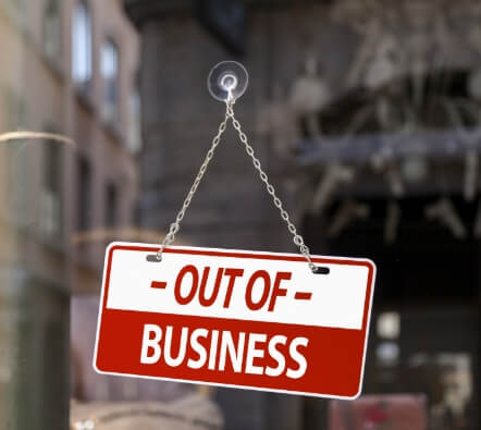 an out of business sign hanging on a store window